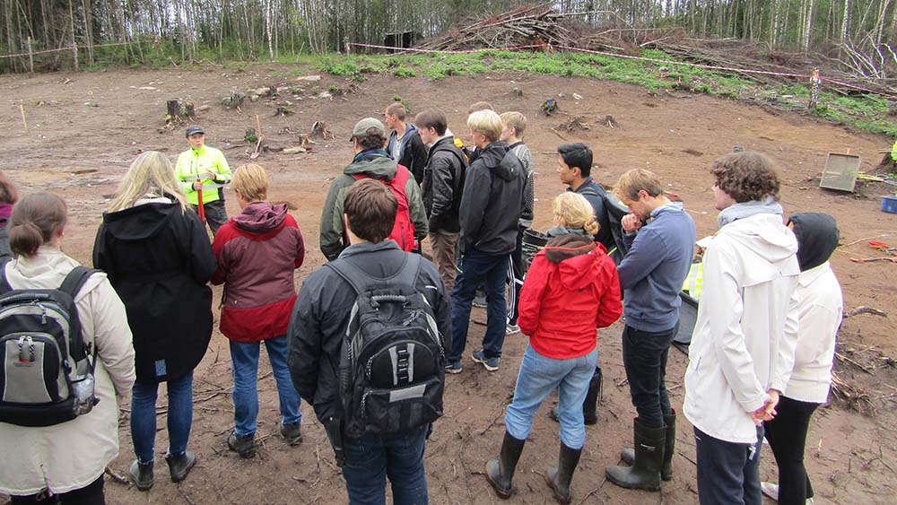 A group of people gathering around an excavation site